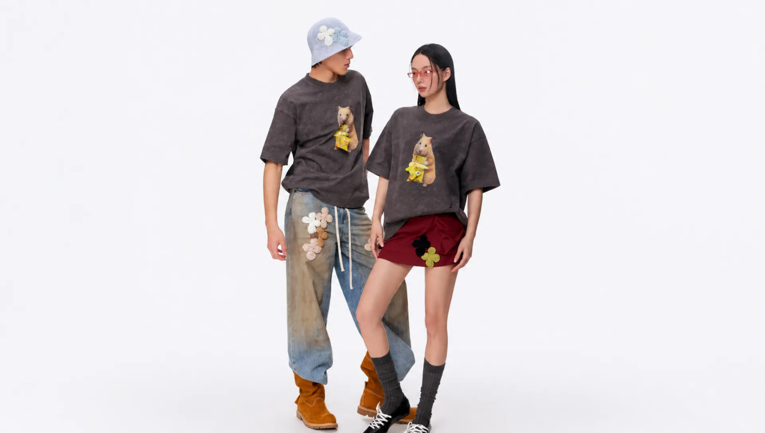 Two people wearing matching t-shirts with bear graphics on a white background